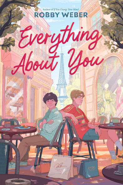 A nice book cover featuring the main character and love interest sitting in an outdoor cafe in Paris, with the Eiffel Tower in background.